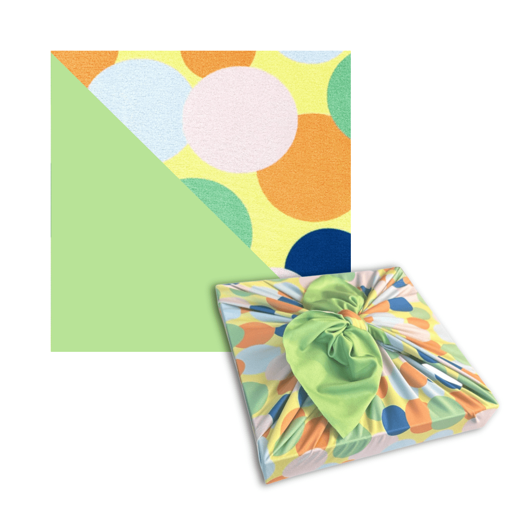 Colorful circle-pattern reusable furoshiki wrap with bright green knotted bow