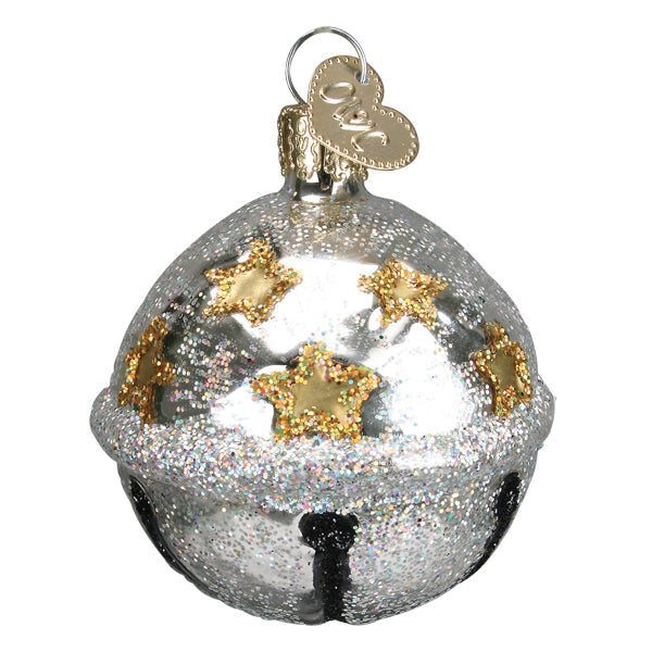 Close-up of silver glitter jingle bell ornament with gold stars and a decorative cap.