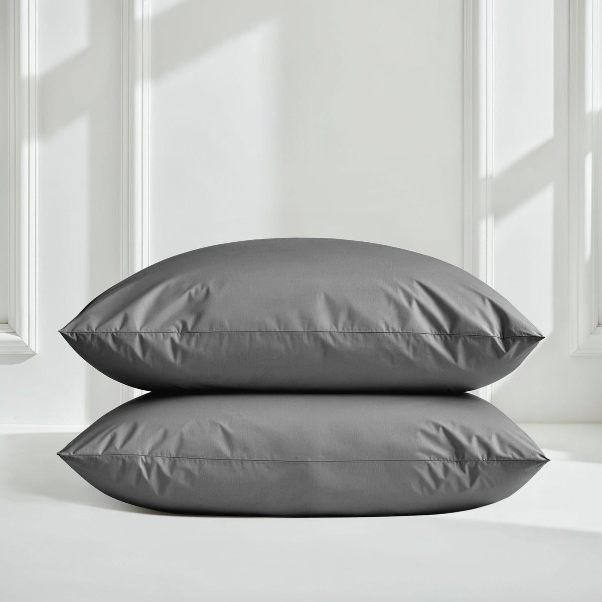 Gray sateen bedding bundle with two smooth envelope pillows.