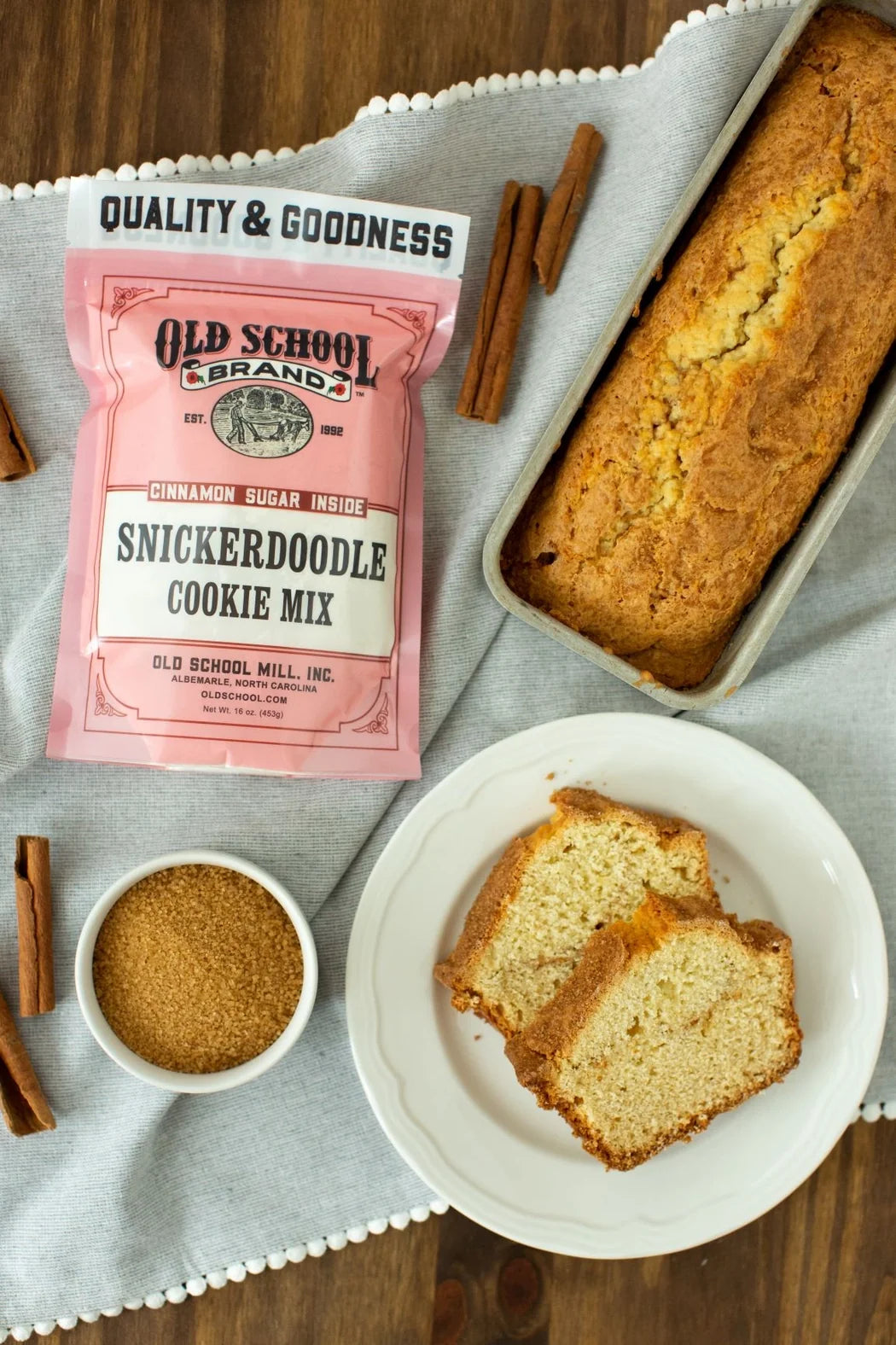 Snickerdoodle cookie mix pouch with a baked loaf slice and a bowl of snickerdoodle cookies
