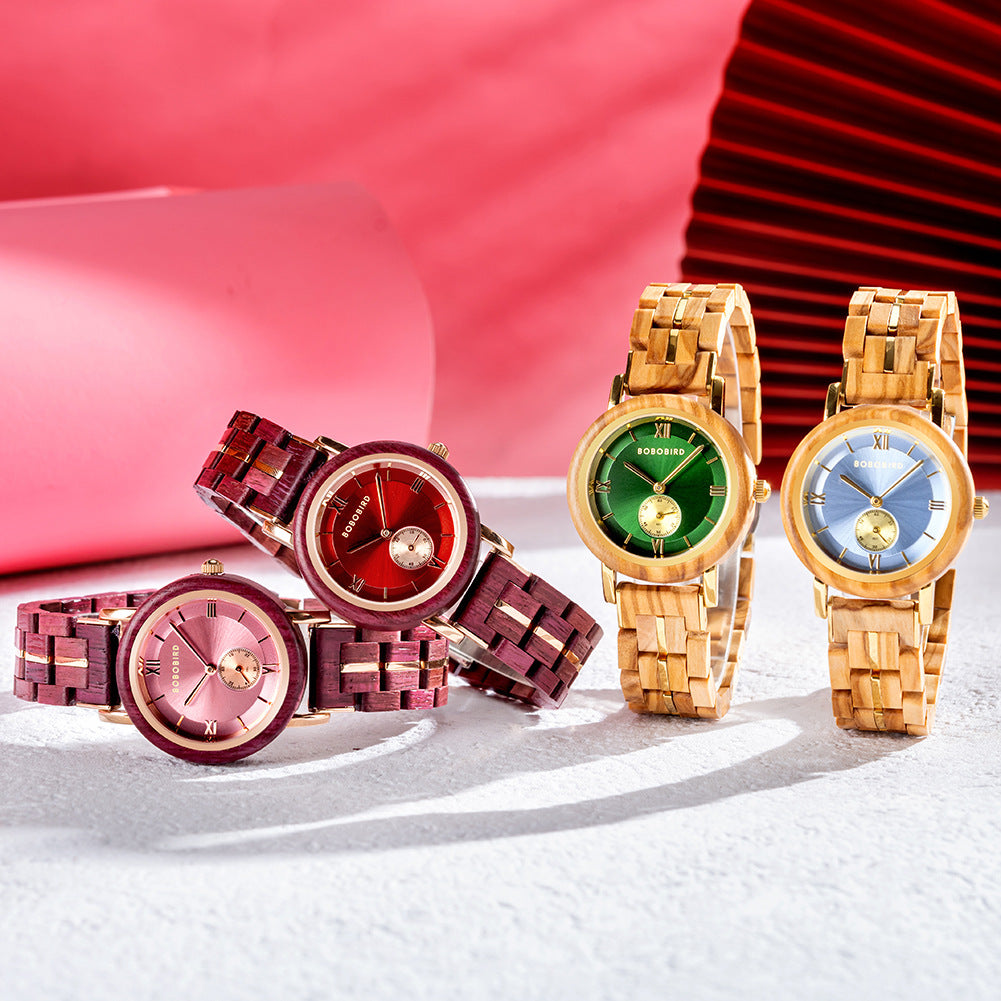 Set of four wooden quartz watches with red, pink, green, and blue dials