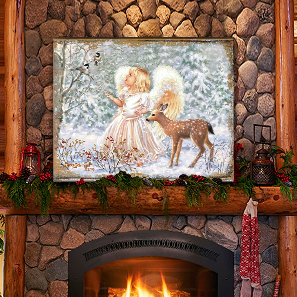 Framed wooden wall art with angel girl holding a deer in snowy winter scene