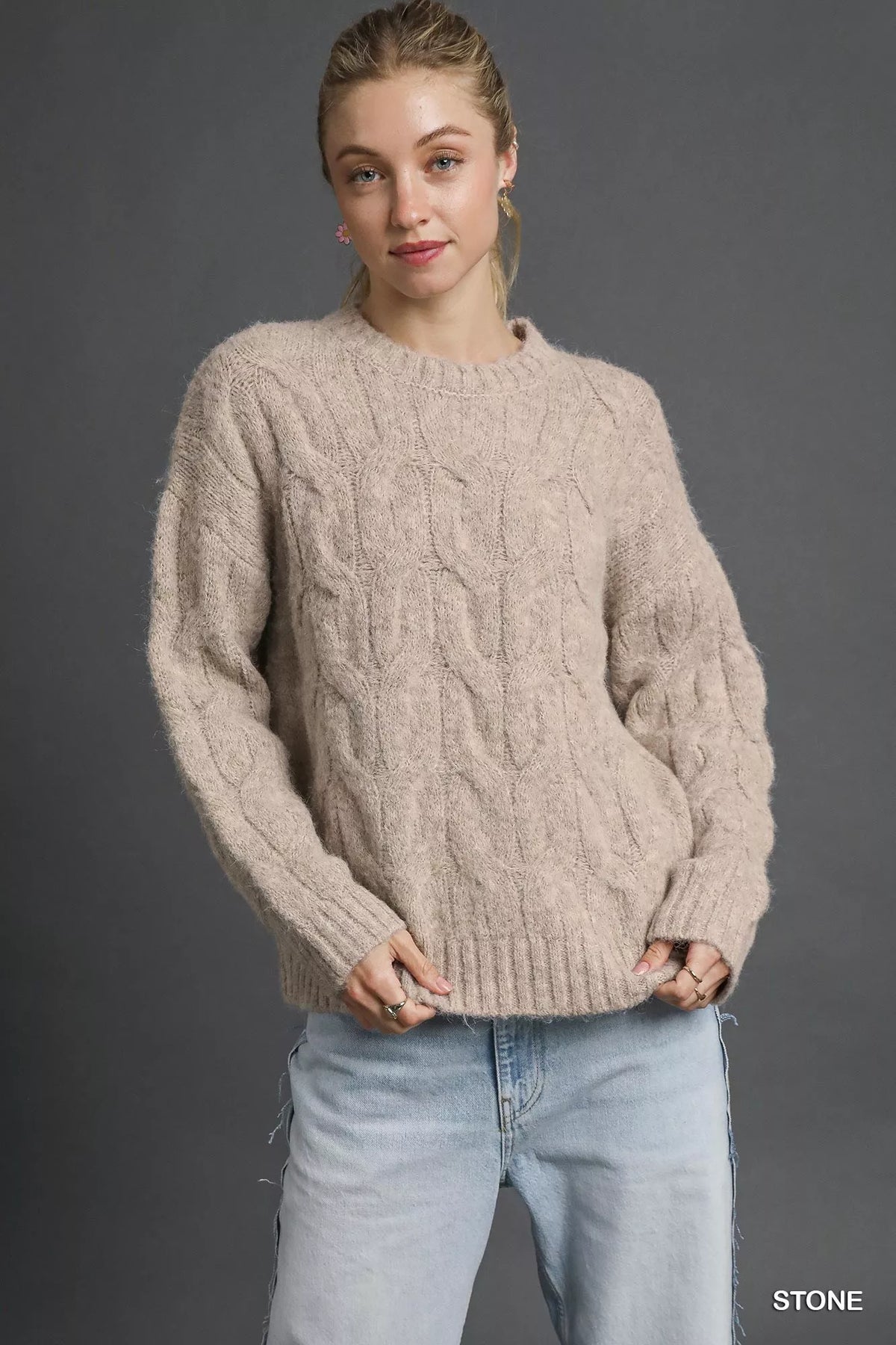 Stone cable-knit cozy sweater with crew neck and long sleeves, ribbed cuffs and hem