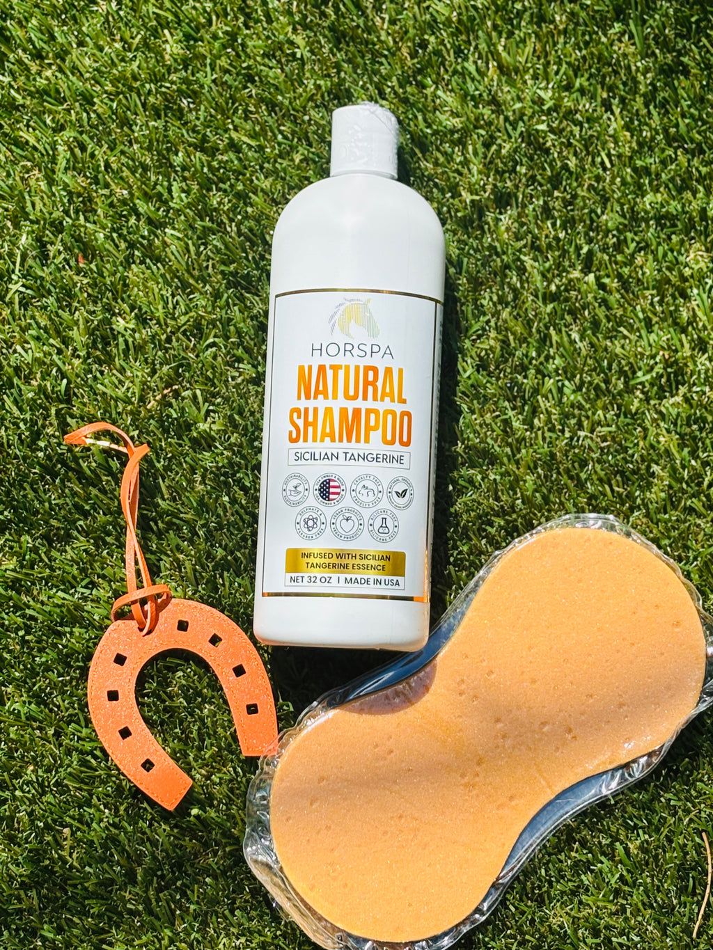 Horspa Natural Shampoo bottle with orange sponge accessory on grass