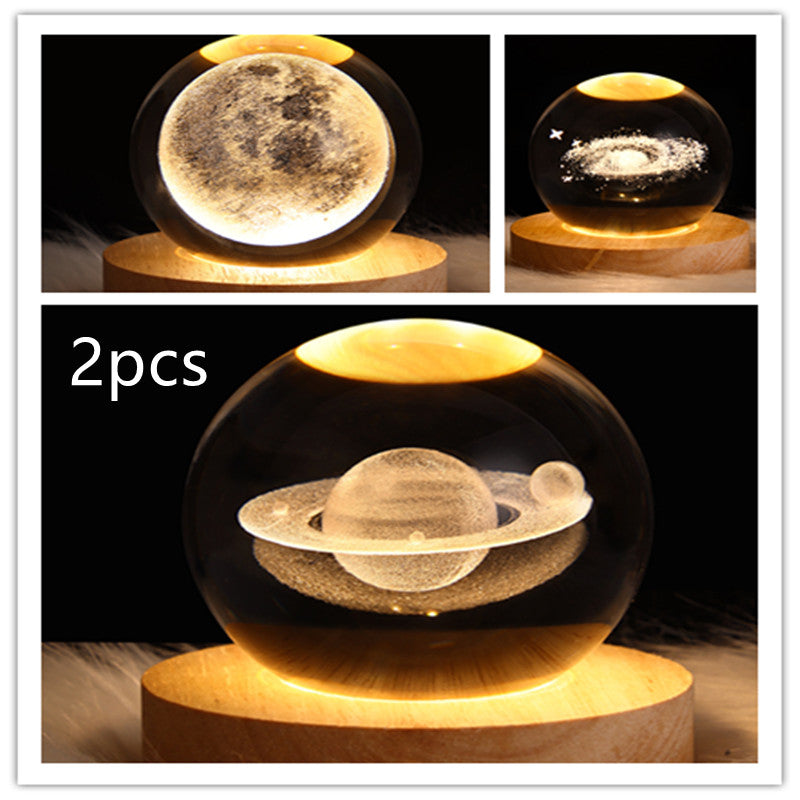 LED galaxy crystal ball table lamp set on wood base with moon, sparkles, and Saturn ring glow
