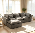 Gray oversized modular sectional sofa with chaise and multiple square throw pillows