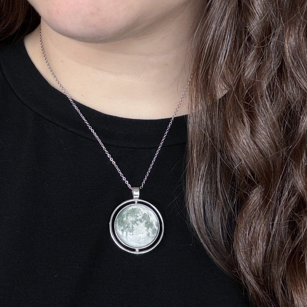 Moon fidget pendant necklace with small round silver-toned pendant on a chain