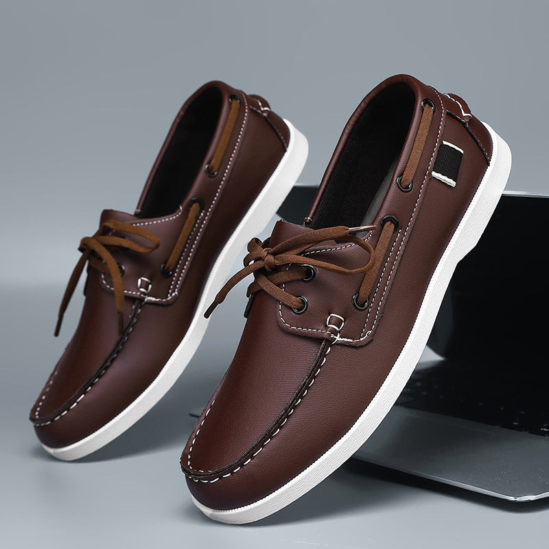 Men's brown lace-up loafers with white sole, front laces, and side eyelets