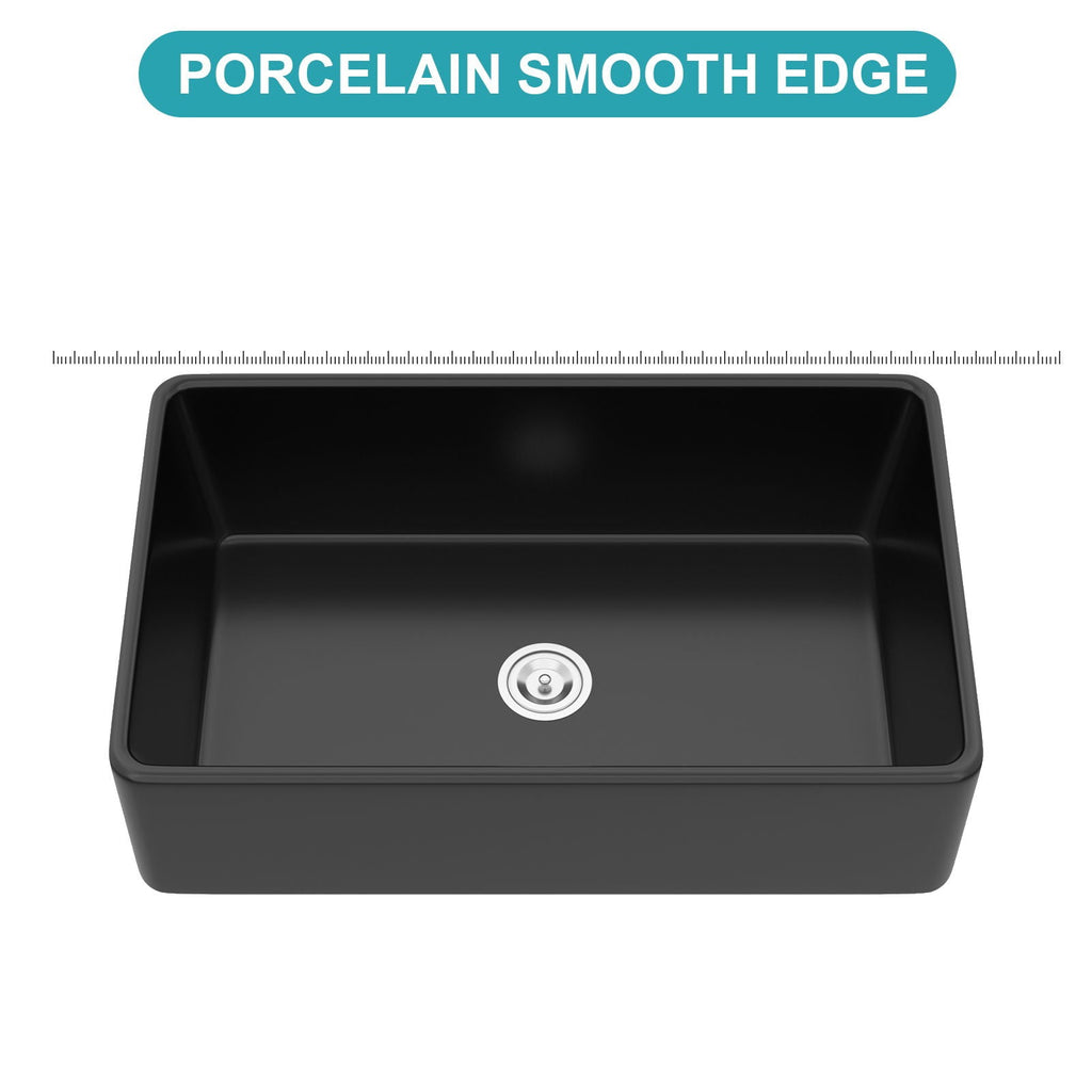 Black ceramic single-bowl sink basin close-up with smooth rim and drain strainer