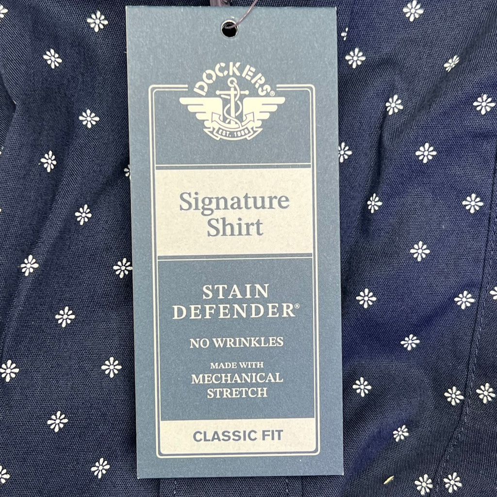 Hang tag on navy shirt reading Signature Shirt and Stain Defender Classic Fit