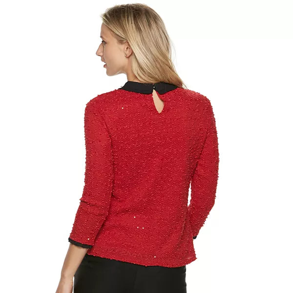 Back view of red 3/4-sleeve collared top with keyhole opening and black trim.