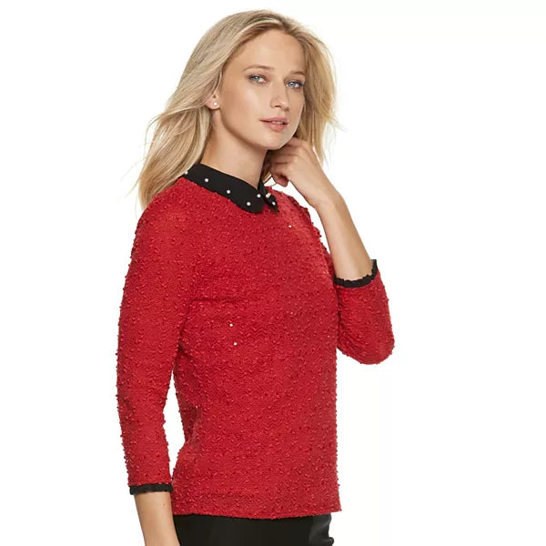 Red 3/4-sleeve collared top with black studded yoke and textured surface.