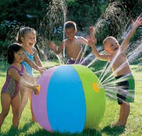Inflatable spray water ball toy with blue and green panels, kids playing outdoors
