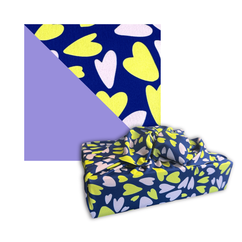 Blue heart-pattern reusable furoshiki cloth wrap with tied knot, yellow and white hearts