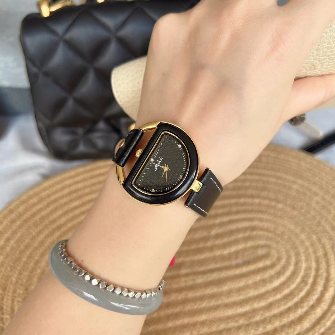 Women’s leather-strap watch with black band and black oval case, dark face.