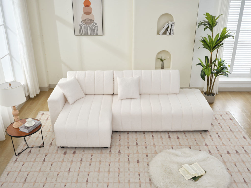 Beige sectional sofa with chaise and rounded back cushions.