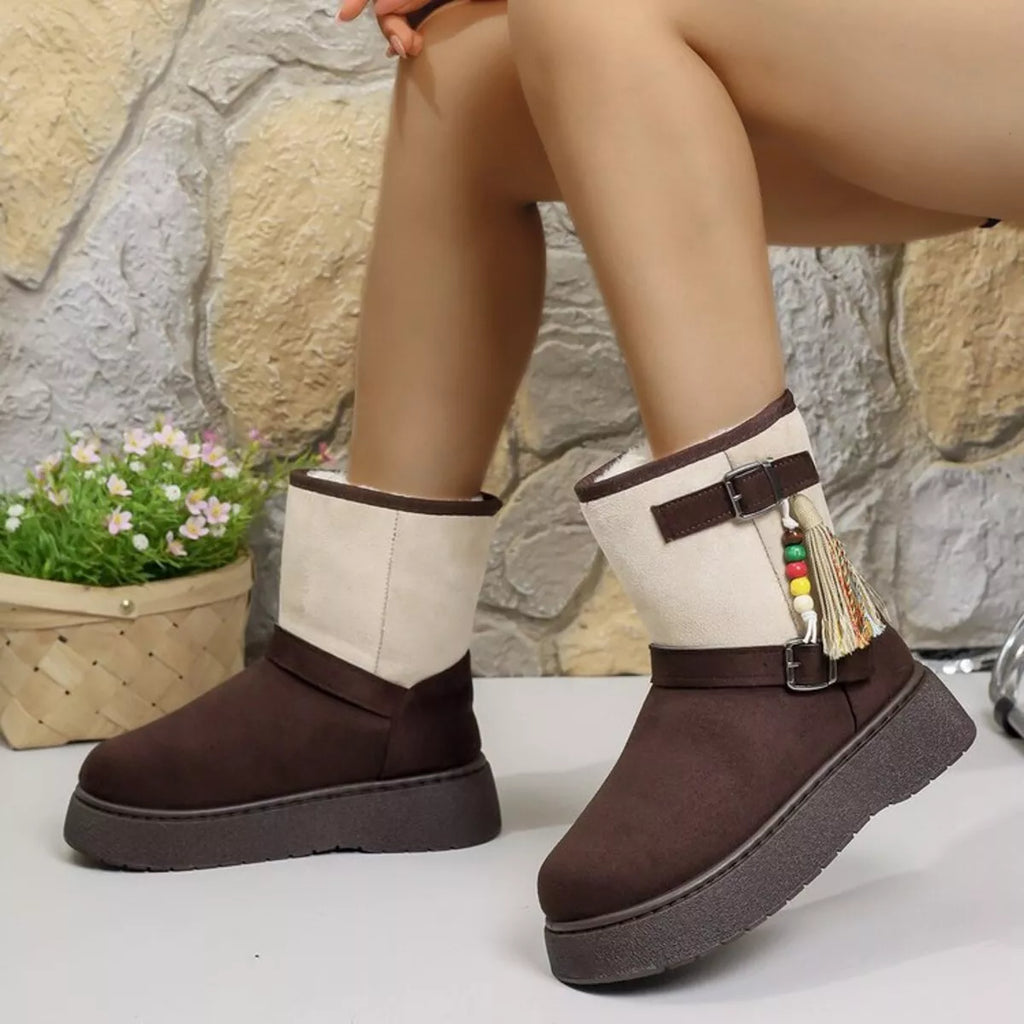 Two-tone ankle boots with white shafts, brown sides, buckled straps, and tassel decor.