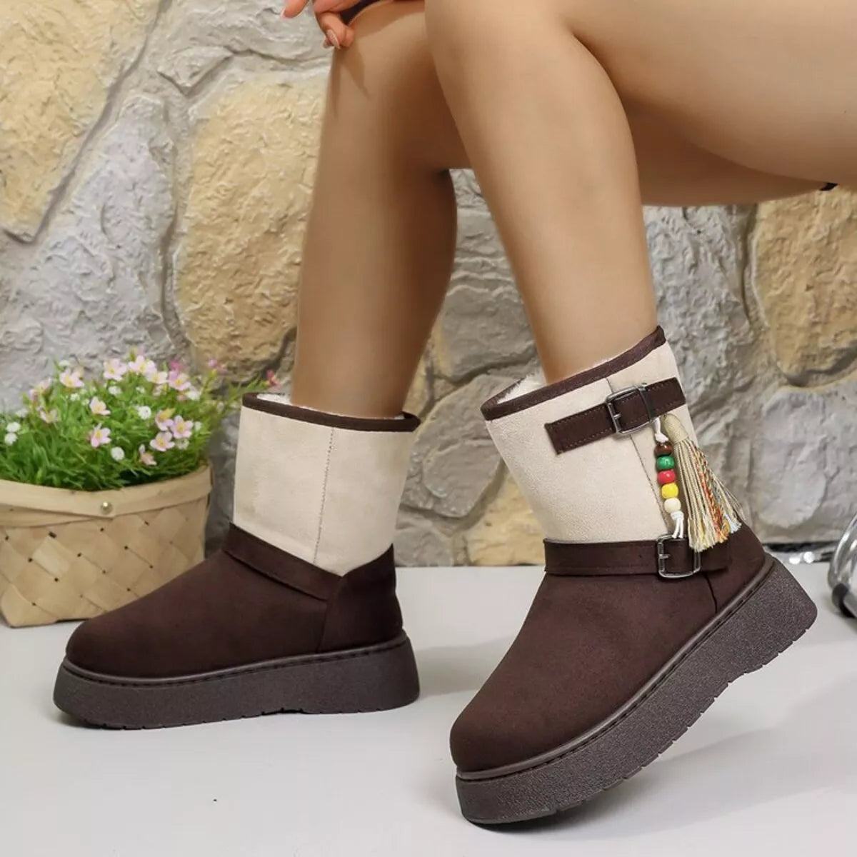 Two-tone ankle boots with white shafts, brown sides, buckled straps, and tassel decor.
