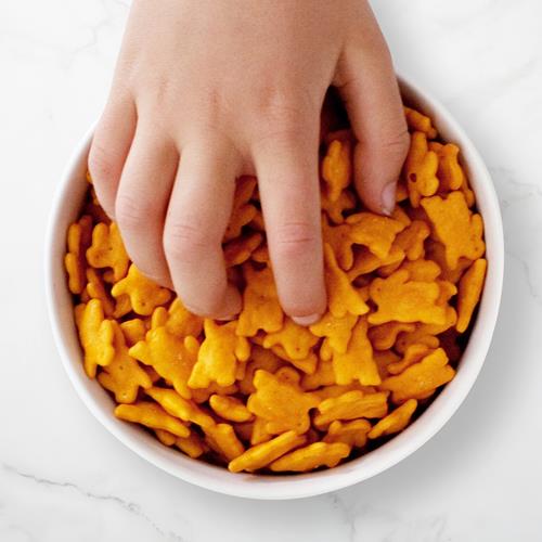 Bowl of baked cheddar bunny snack crackers, orange shapes.