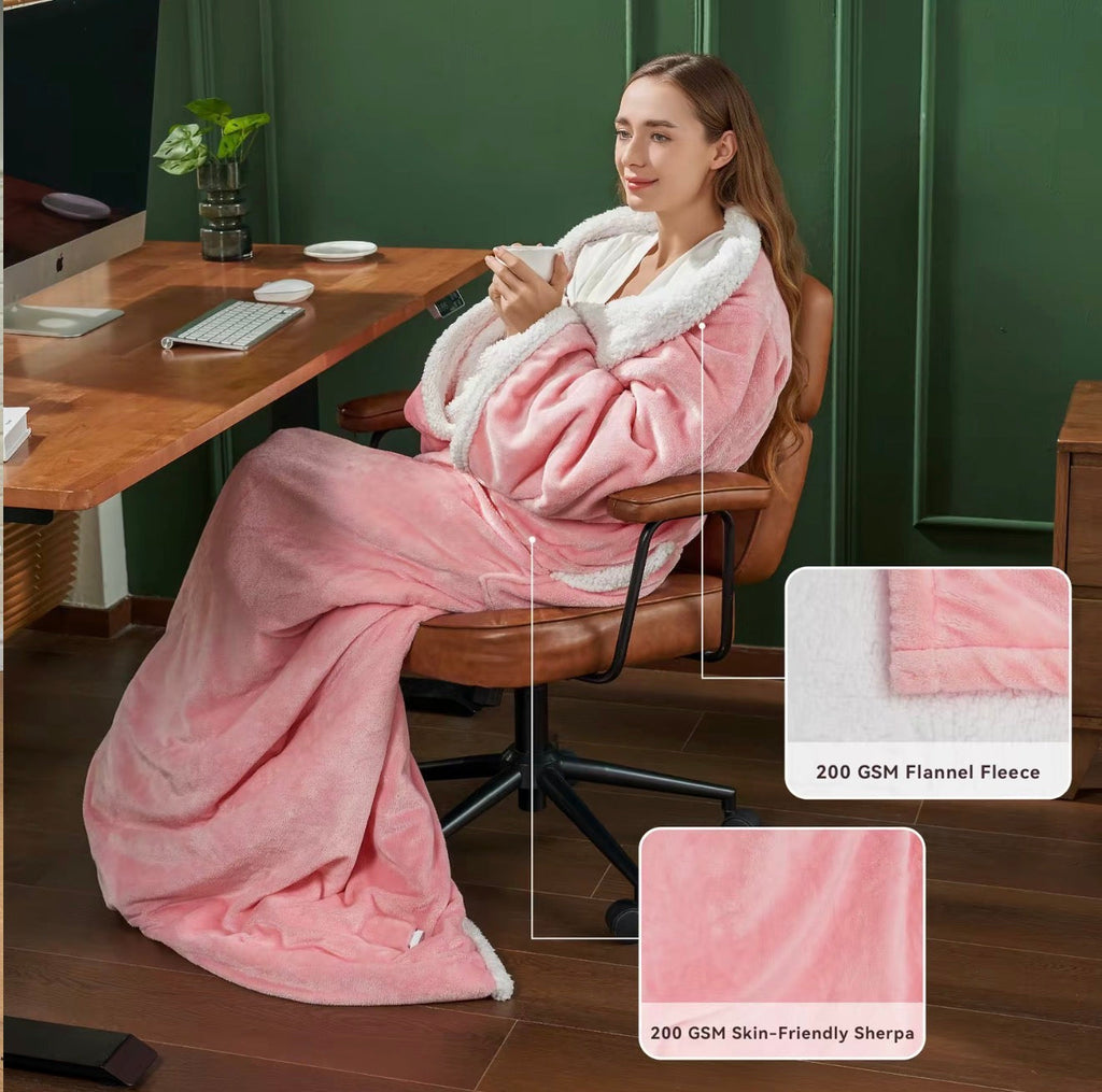Pink hooded heated wearable blanket with sherpa collar and drawstring, seated
