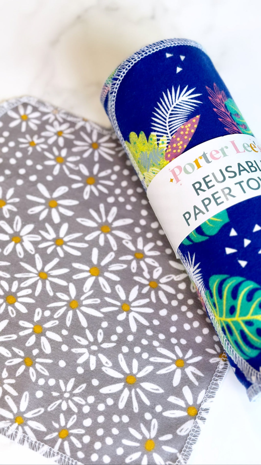 Reusable paper towel roll in navy blue with tropical leaf and triangle patterns