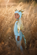 Sky blue dragon costume with gold spiked headpiece, hooded jumpsuit, and winged accents.