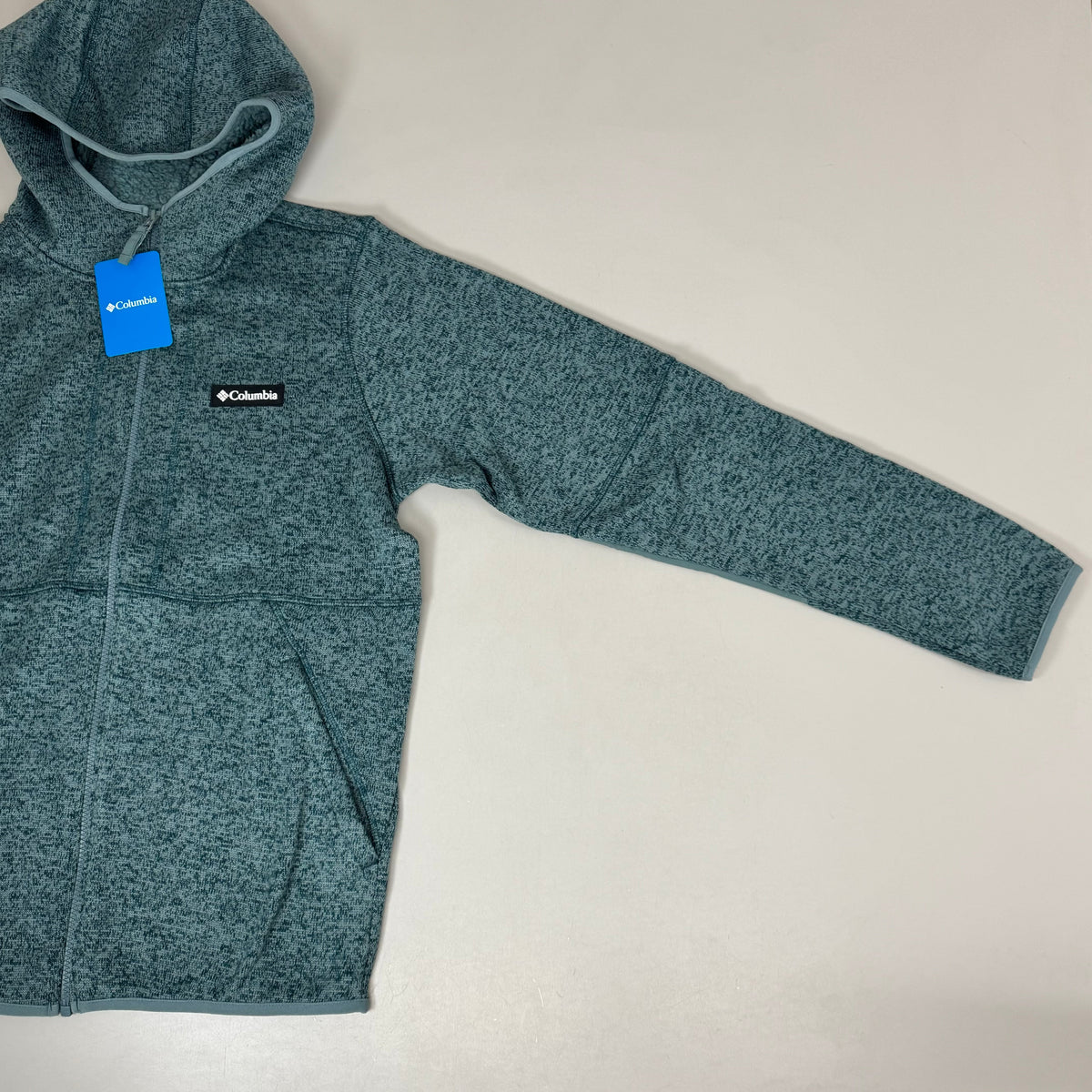 Men's teal fleece hooded full-zip jacket, side view with sleeve pockets