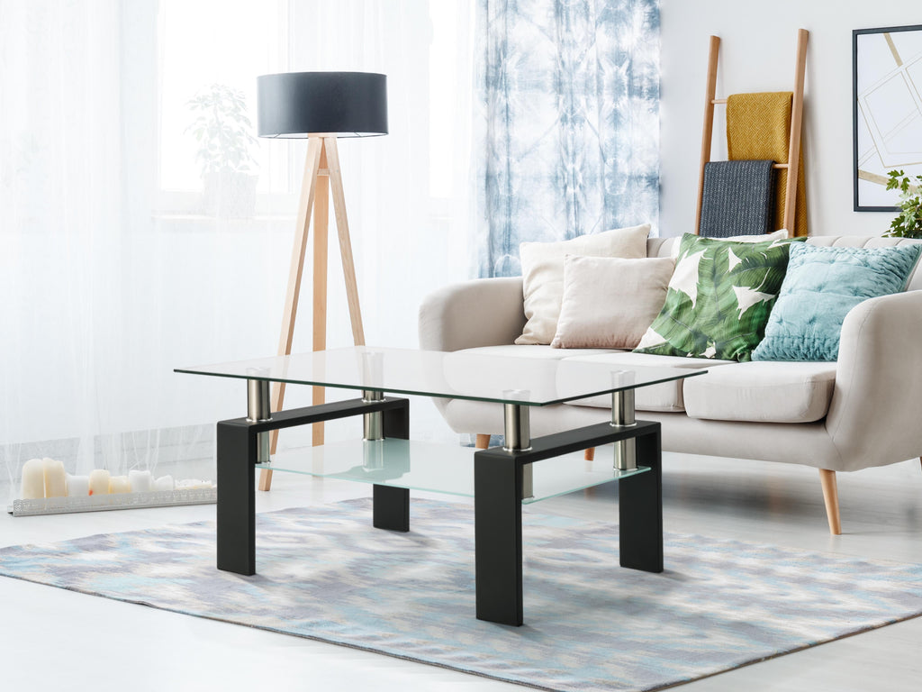 Rectangular black glass coffee table with clear top, lower shelf, and four posts