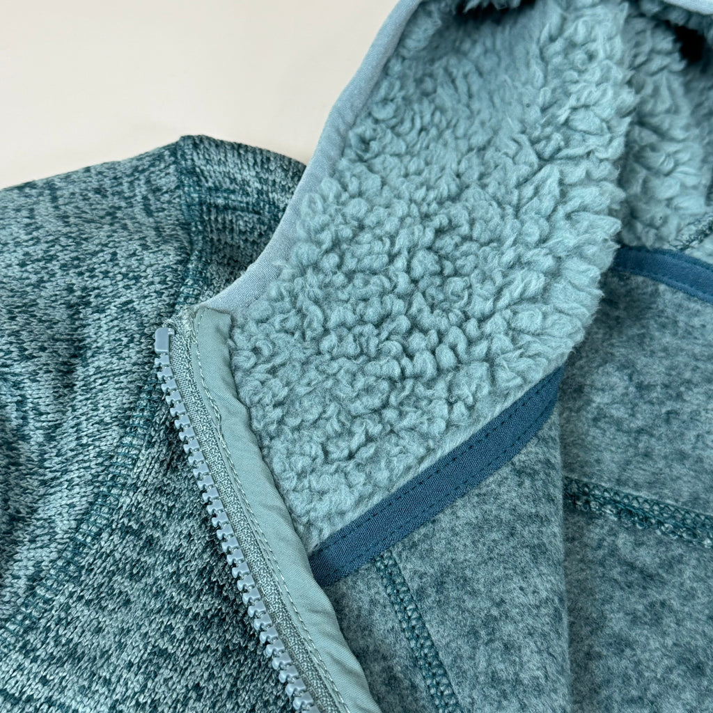 Sherpa-lined hood detail on men's teal fleece full-zip jacket