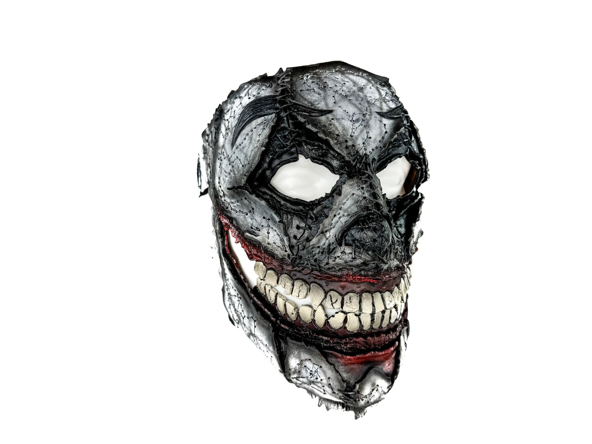 Full-face leather mask, gray cracked texture, red banding along mouth, realistic teeth