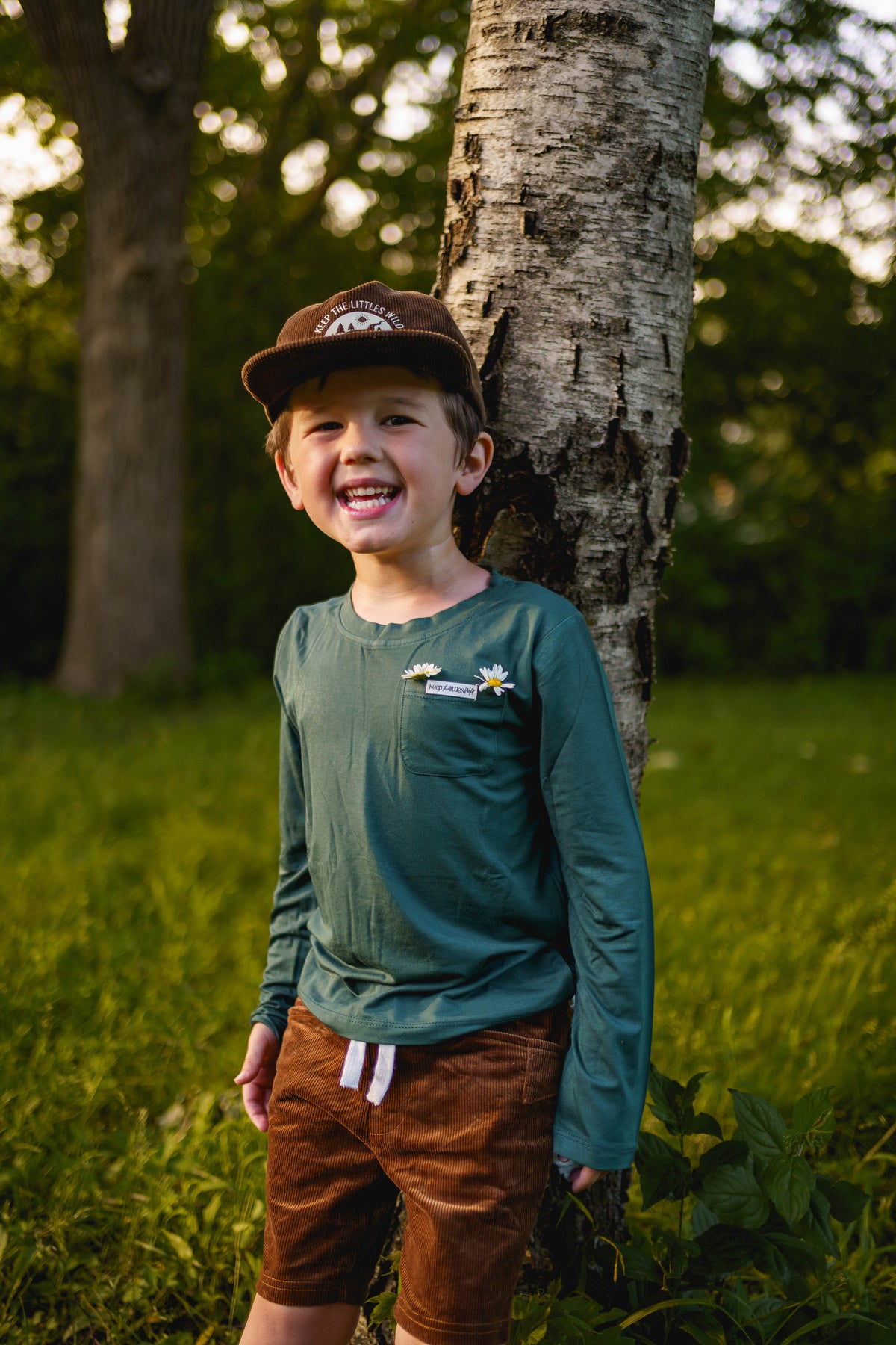 Teal kids long-sleeve T-shirt with small chest badge graphic