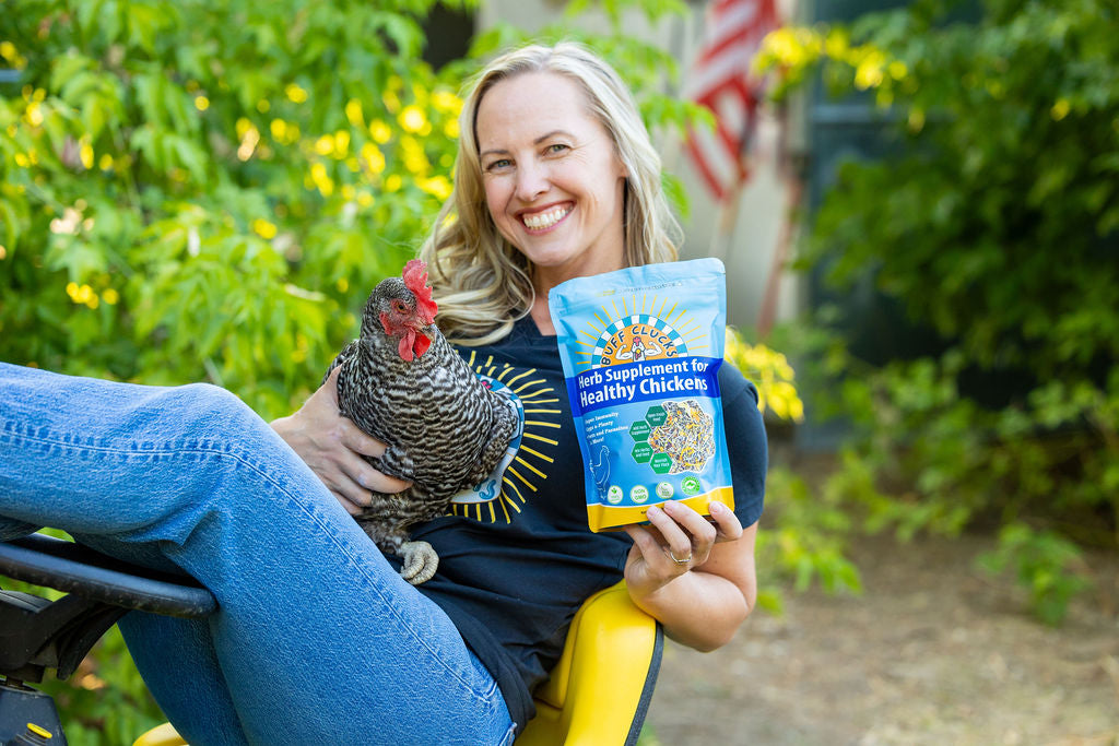 Blue herb supplement pouch held near a barred chicken