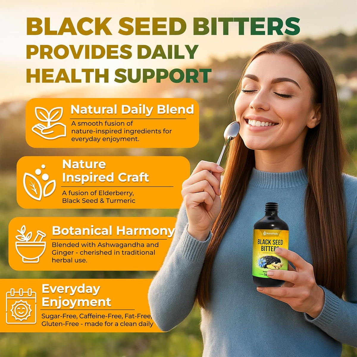 Black seed bitters bottle held by smiling woman in blue sweater.