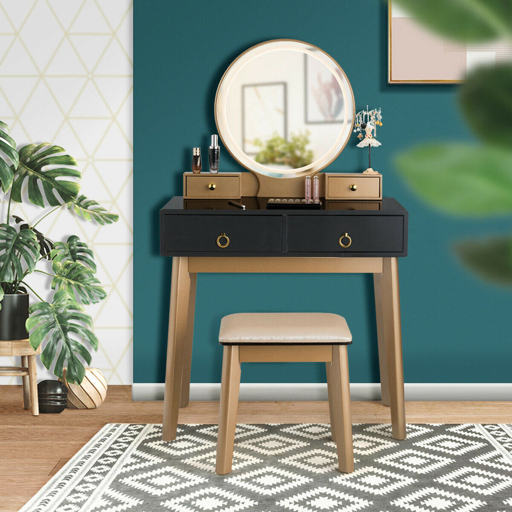 Makeup vanity table set with illuminated round mirror, black drawers, wood legs, and beige stool