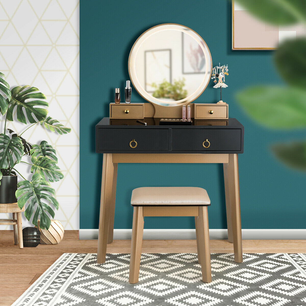 Makeup vanity table set with illuminated round mirror, black drawers, wood legs, and beige stool