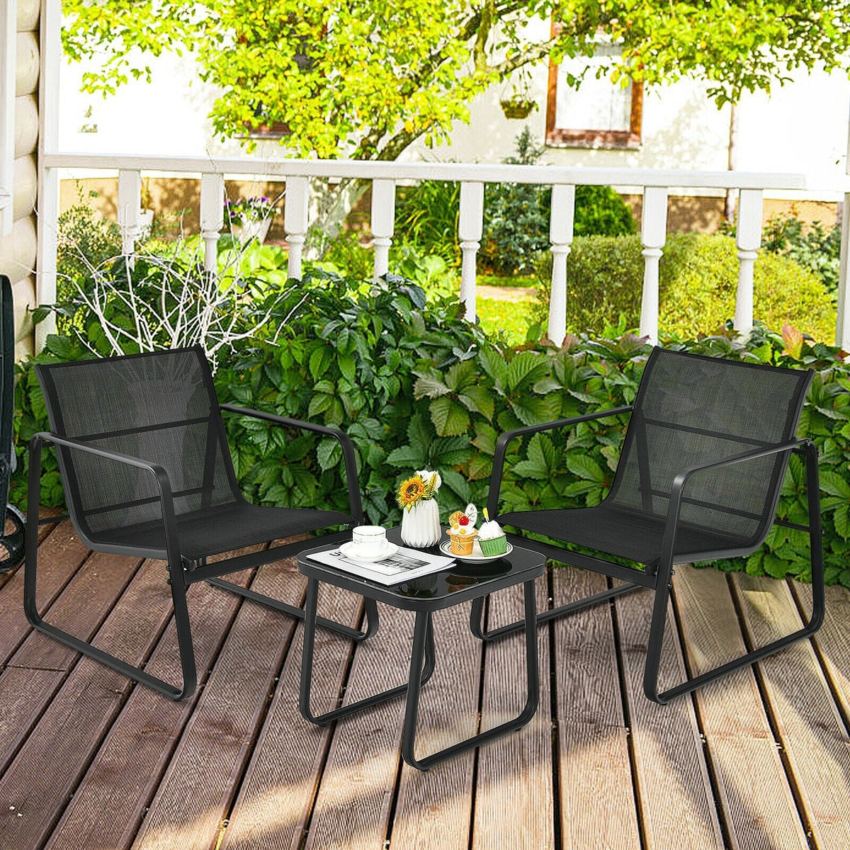 Black patio bistro set on deck: two mesh chairs and glass top table