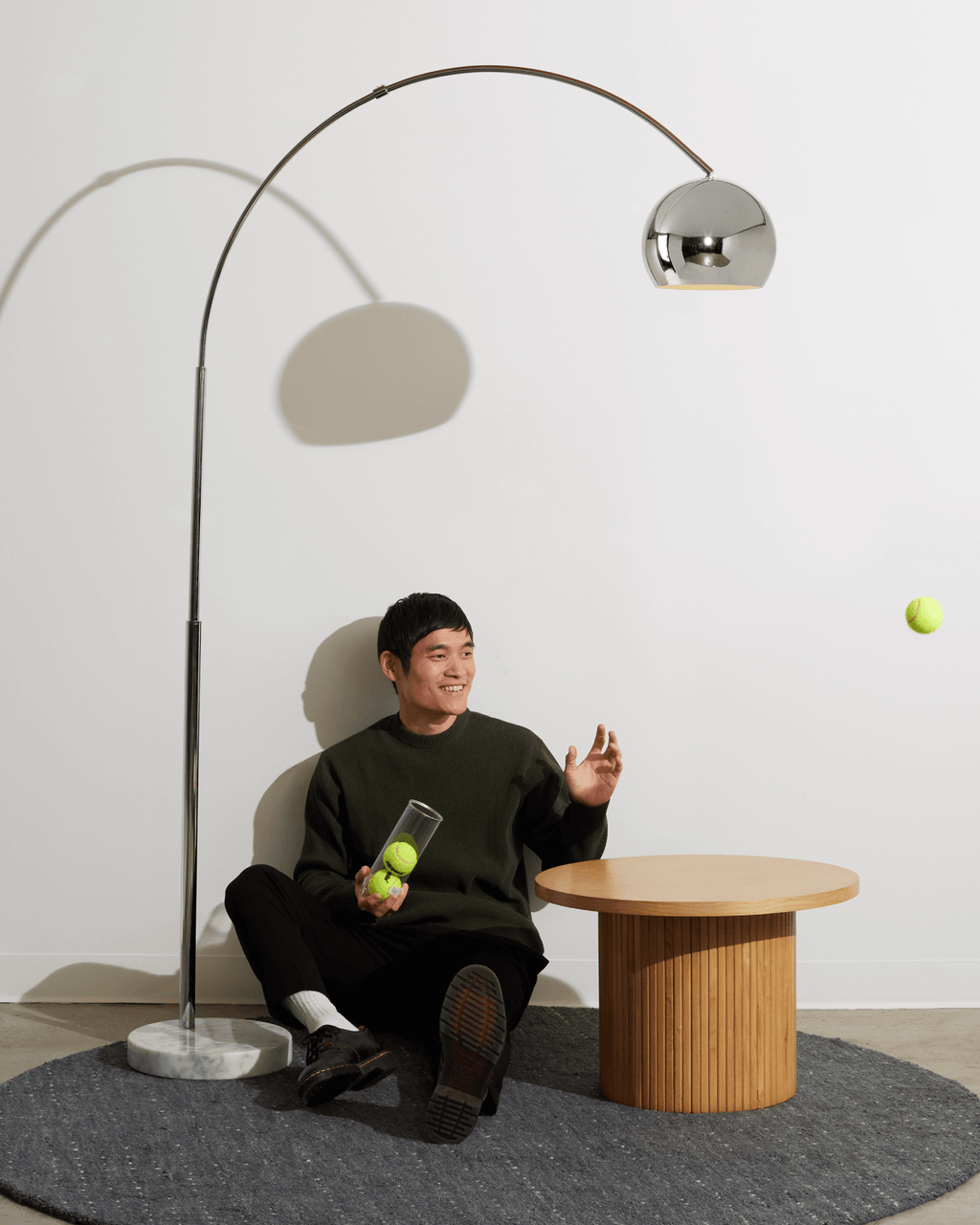 Bronze floor lamp with curved arch and spherical dome shade