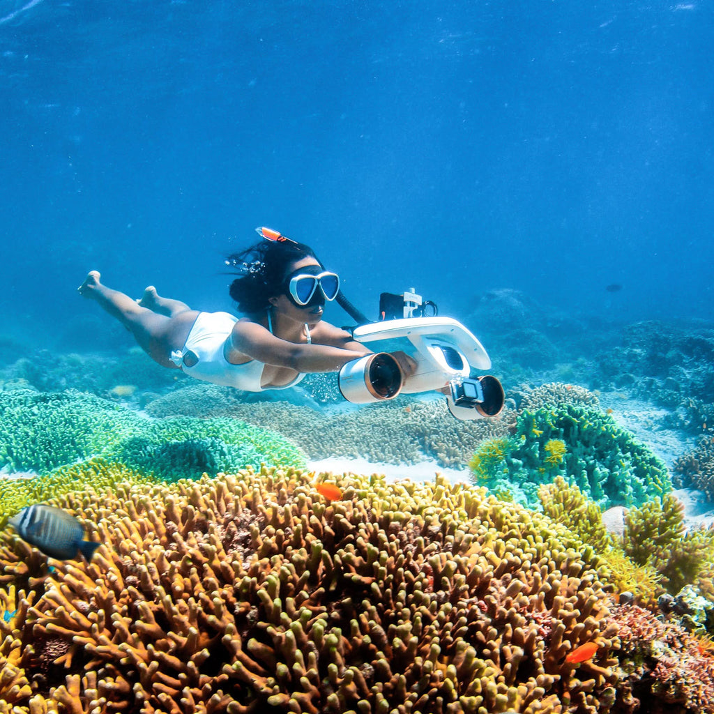 Underwater drone with wide front camera, scuba diver over reef