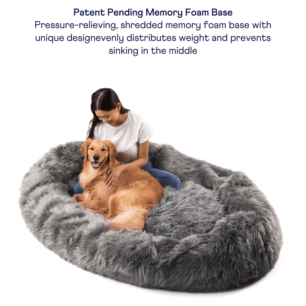 Charcoal grey faux fur dog bed with memory foam base, viewed from above