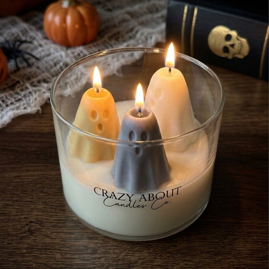 Halloween ghost trio soy candle in clear glass tumbler with three lit ghost candles