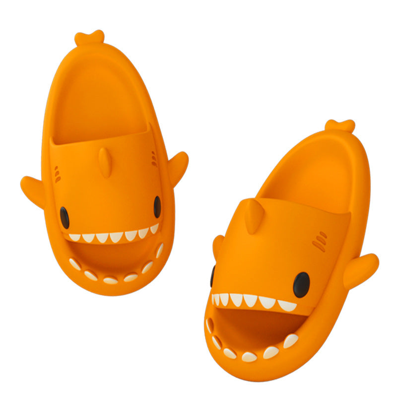 Orange shark-shaped slide sandals, open toe with white teeth and fin accents