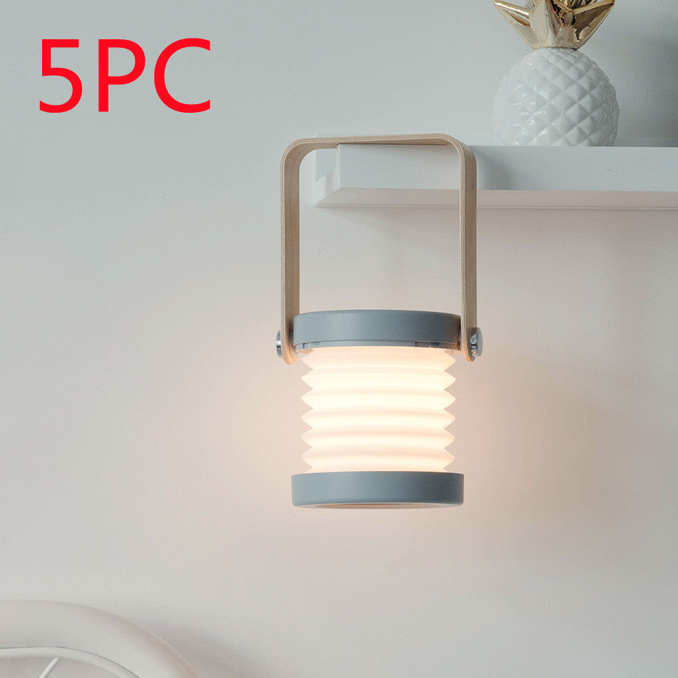 Foldable LED lantern with ribbed shade, light wood frame and gray base