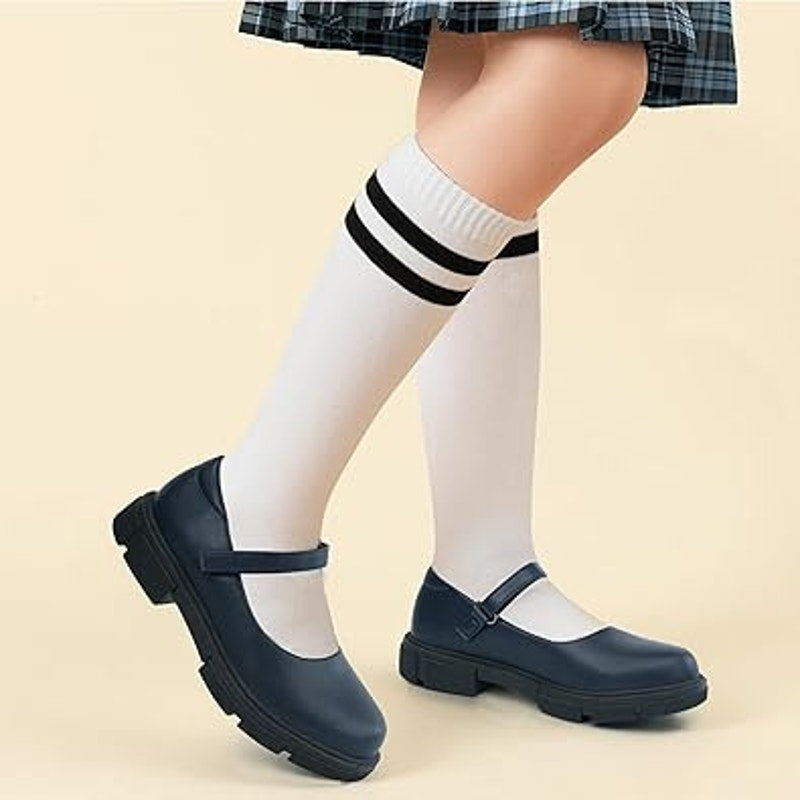 Navy toddler Mary Jane school shoes on feet with low heel and hook-and-loop strap