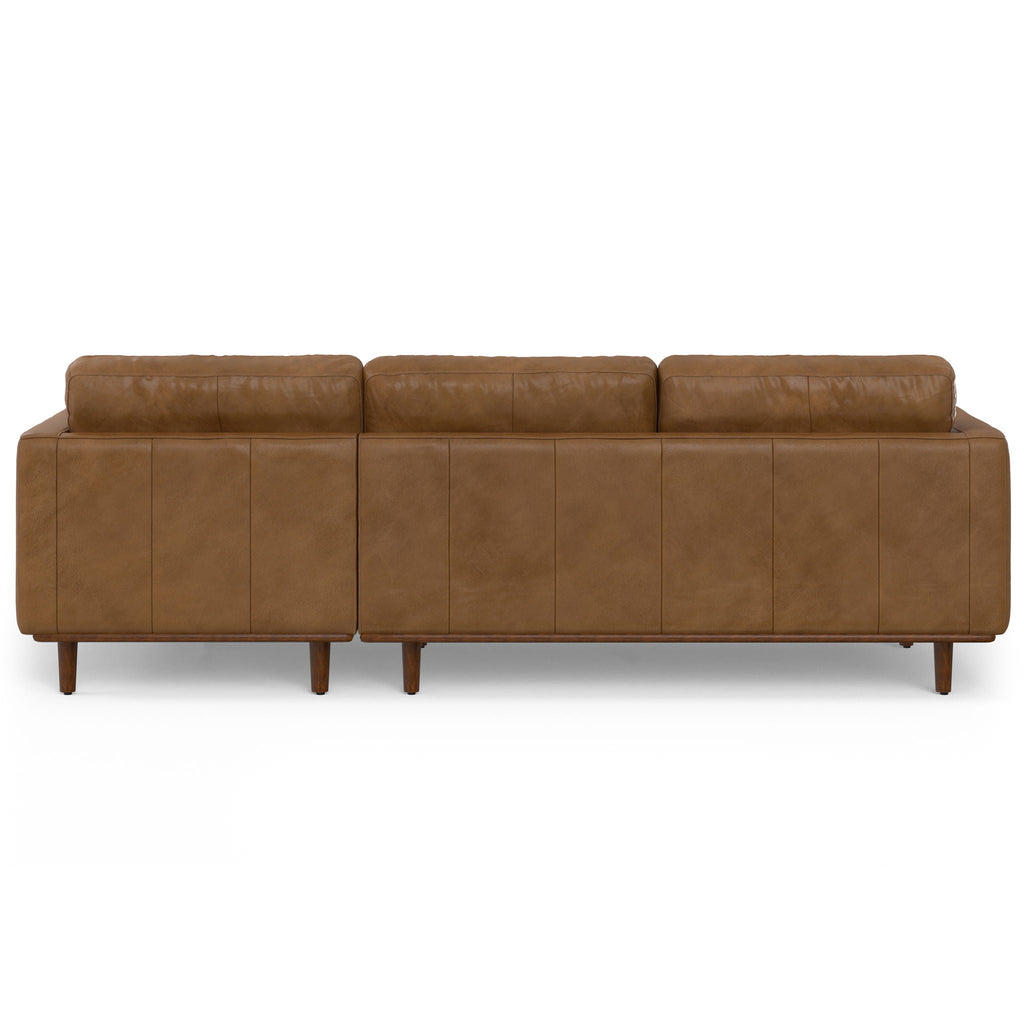 Light brown leather sectional sofa with tufted panel stitching and tapered wooden legs