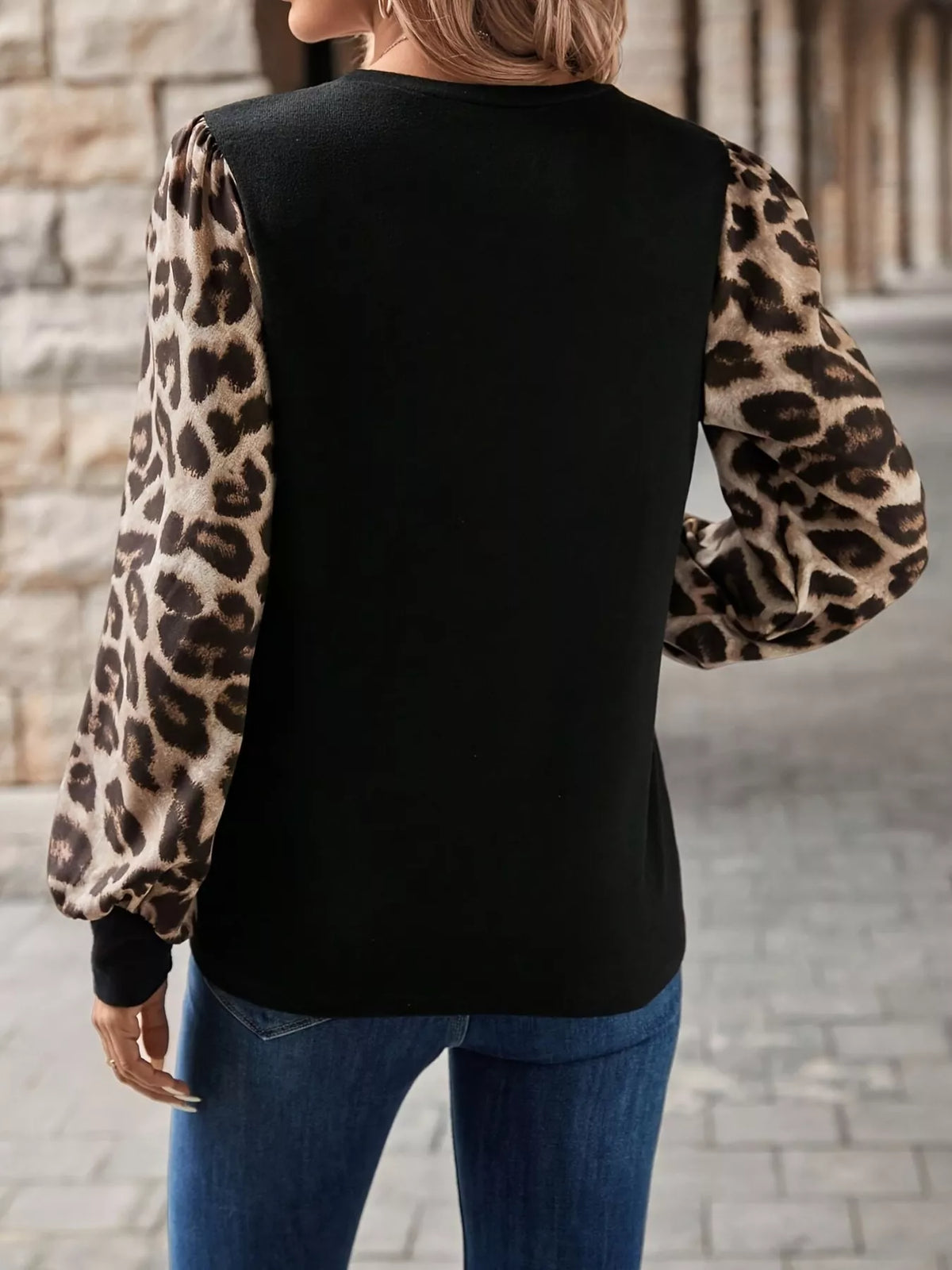 Black long sleeve round-neck T-shirt with leopard print puff sleeves, back view