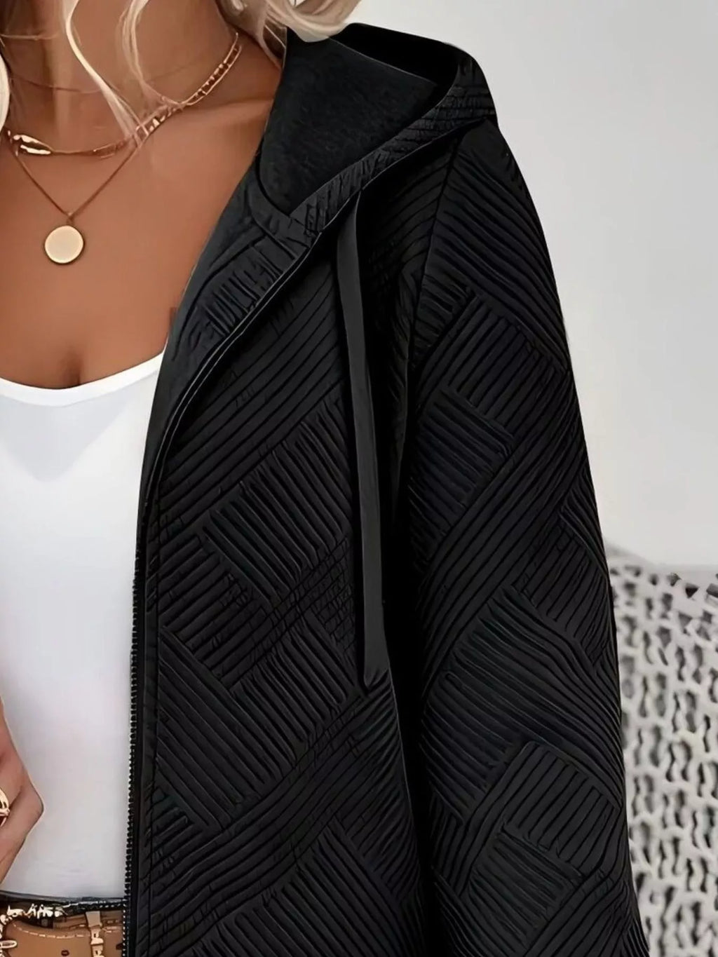 Black textured zip-up hooded jacket, diagonal chevron-like pattern, front zipper