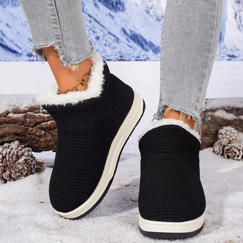 Black knit ankle boots with white plush trim and sidewall platform sole