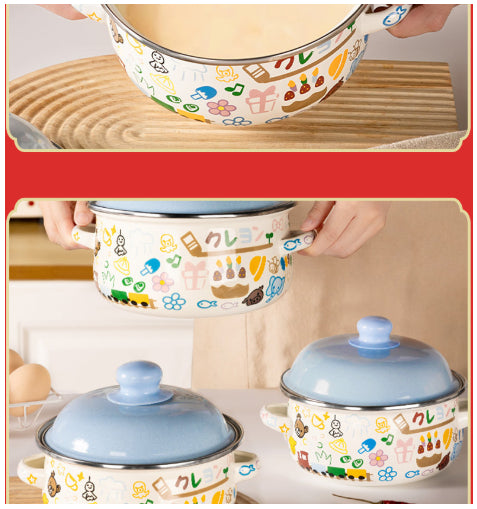 Enamel noodle bowl set with blue lids and handles, shown being held over wood.