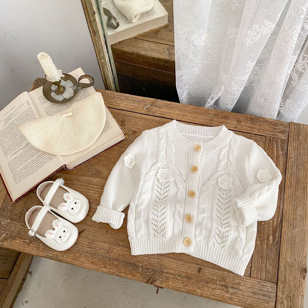 Cream baby knit jacket with flower cable embroidery, button front and ribbed cuffs