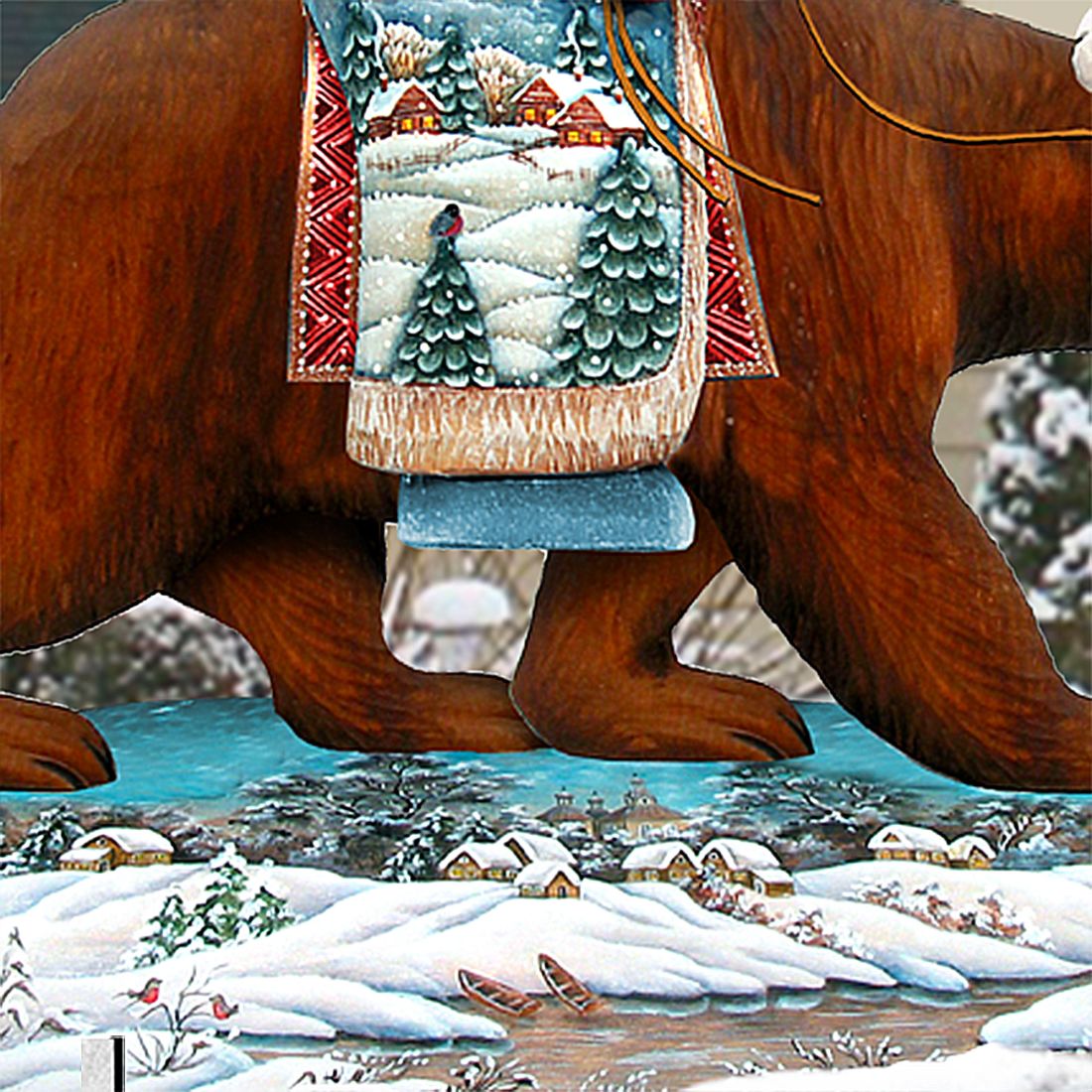 Close-up of Santa on grizzly bear decor: patterned coat and snowy base with pine trees
